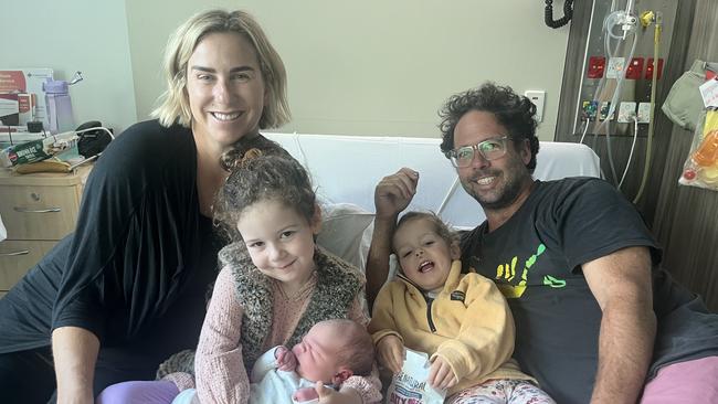 Caitlin McCombe gave birth to son Jock on the bathroom floor on Thursday. Pictured with Clementine, 4, Imogen, 2, and husband Jarred.