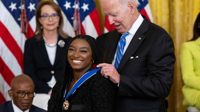 Biles receives the highest civilian honour. (Photo by SAUL LOEB / AFP)