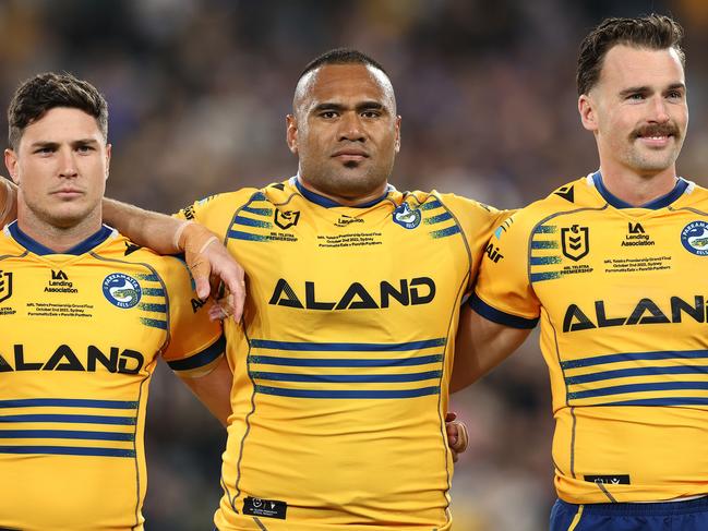 SYDNEY, AUSTRALIA - OCTOBER 02: Mitchell Moses, Junior Paulo and Clinton Gutherson of the Eels line up for the national anthem during the 2022 NRL Grand Final match between the Penrith Panthers and the Parramatta Eels at Accor Stadium on October 02, 2022, in Sydney, Australia. (Photo by Mark Kolbe/Getty Images)