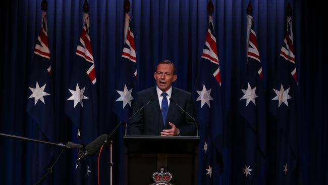 Prime Minister Tony Abbott flies the flag during his National Security Statement at the AFP Headquarters in Canberra.