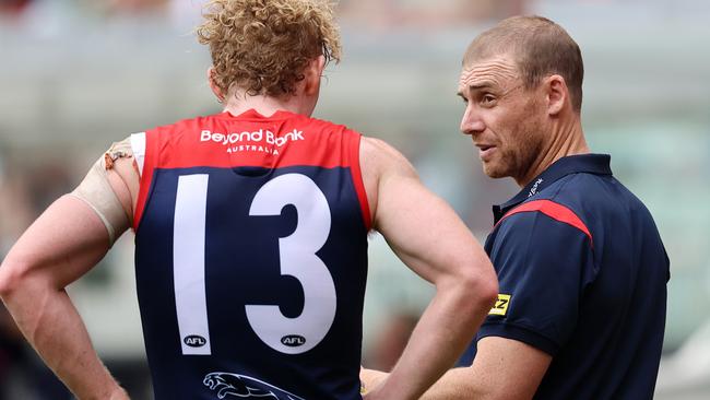 Simon Goodwin talks with Clayton Oliver on the boundary line. Picture: Michael Klein