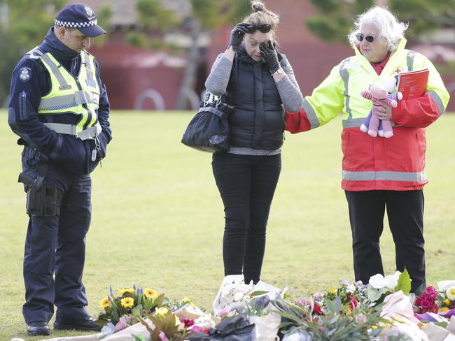 Floral tributes gather at the Carlton North field. Pictures: Wayne Taylor