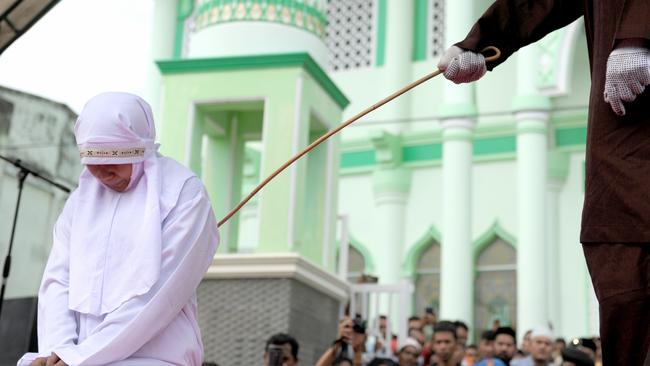 A Muslim woman is caned after being caught in proximity with her boyfriend in Banda Aceh.