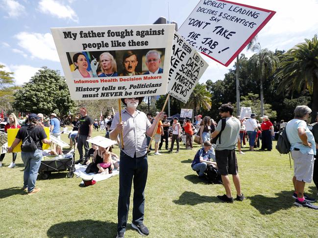 A protester holds up signs at the protest. Picture: NCA NewsWire / Josh Woning