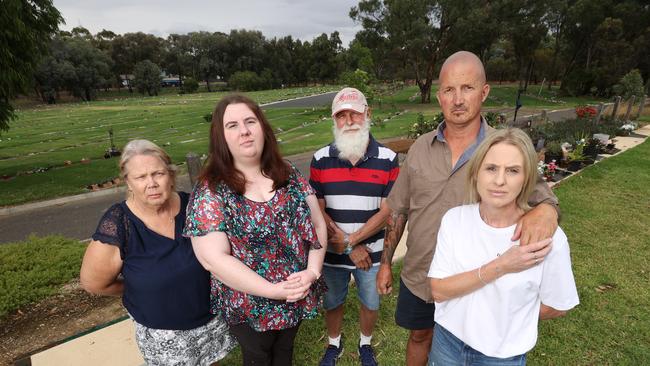 Grieving families Peter and Pauline Burns with their niece Abby and Marc and Anita Sertori are angry decorations and trinkets will have to be removed from the graves of their loved ones at the Bendigo Cemetery. Picture: David Caird