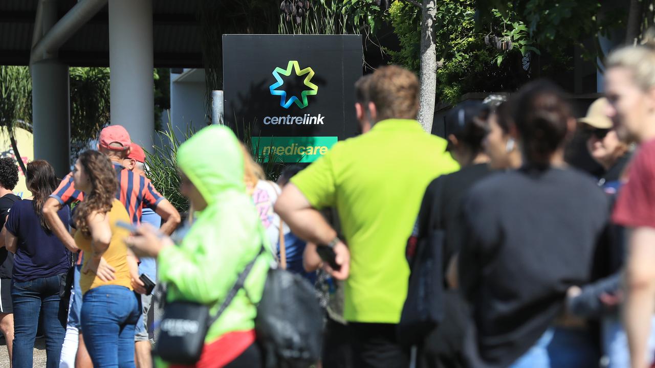 Lines of people wait at Southport Centrelink. Picture: Adam Head.