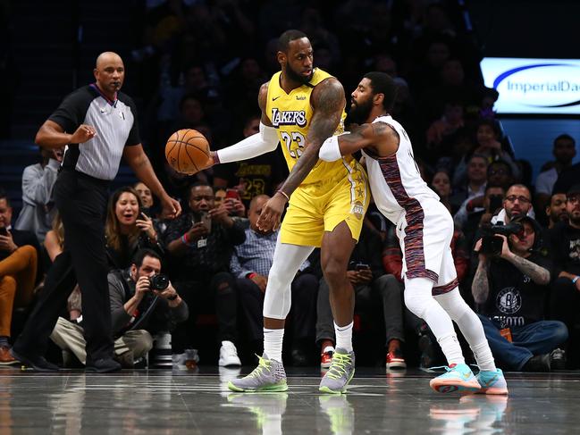 NEW YORK, NEW YORK - JANUARY 23:  LeBron James #23 of the Los Angeles Lakers drives to the basket against Kyrie Irving #11 of the Brooklyn Nets at Barclays Center on January 23, 2020 in New York City. NOTE TO USER: User expressly acknowledges and agrees that, by downloading and or using this photograph, User is consenting to the terms and conditions of the Getty Images License Agreement.   (Photo by Mike Stobe/Getty Images)