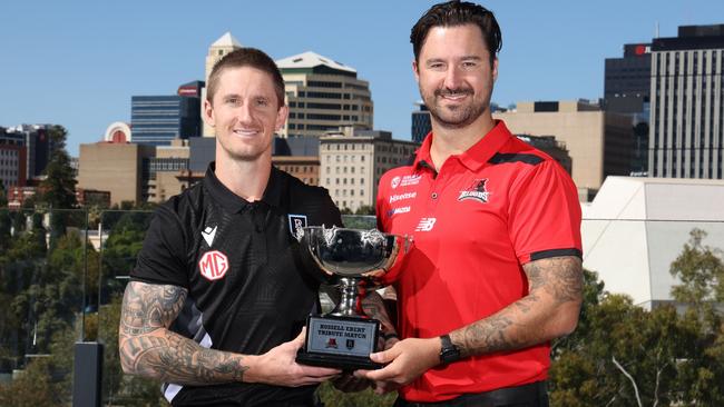 West Adelaide coach Adam Hartlett (right) with his brother and Port Adelaide SANFL coach Hamish Hartlett and the Russell Ebert Tribute Match trophy that the two clubs play for annually. Picture: David Mariuz/ SANFL
