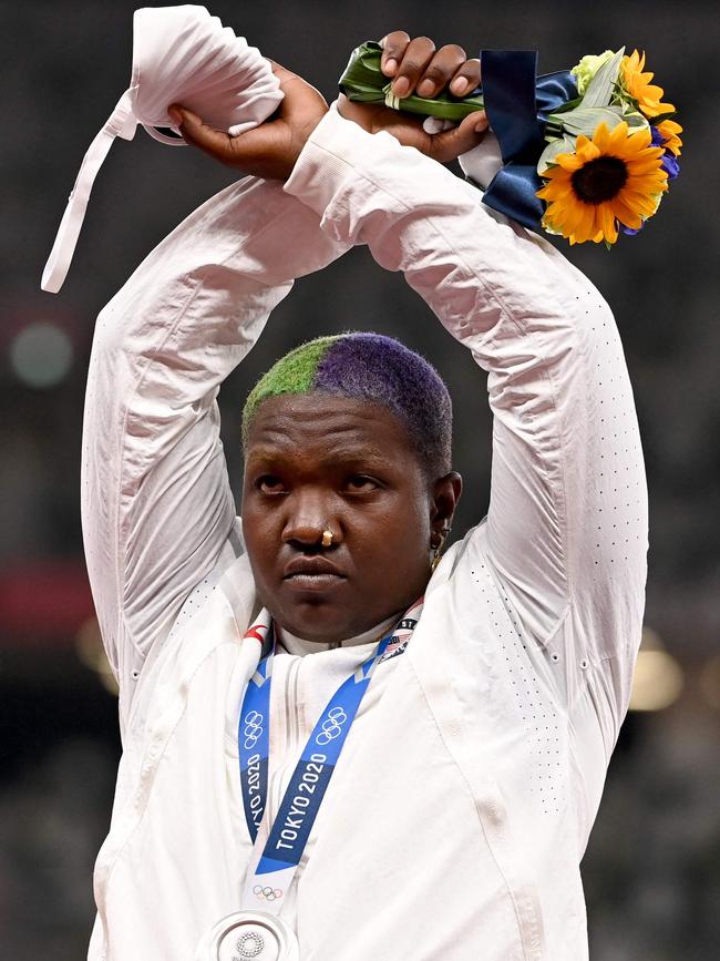 Raven Saunders of the US raises her arms in support of ‘the oppressed’ on the podium after winning the silver medal in the women's shot put event. Picture: AFP.