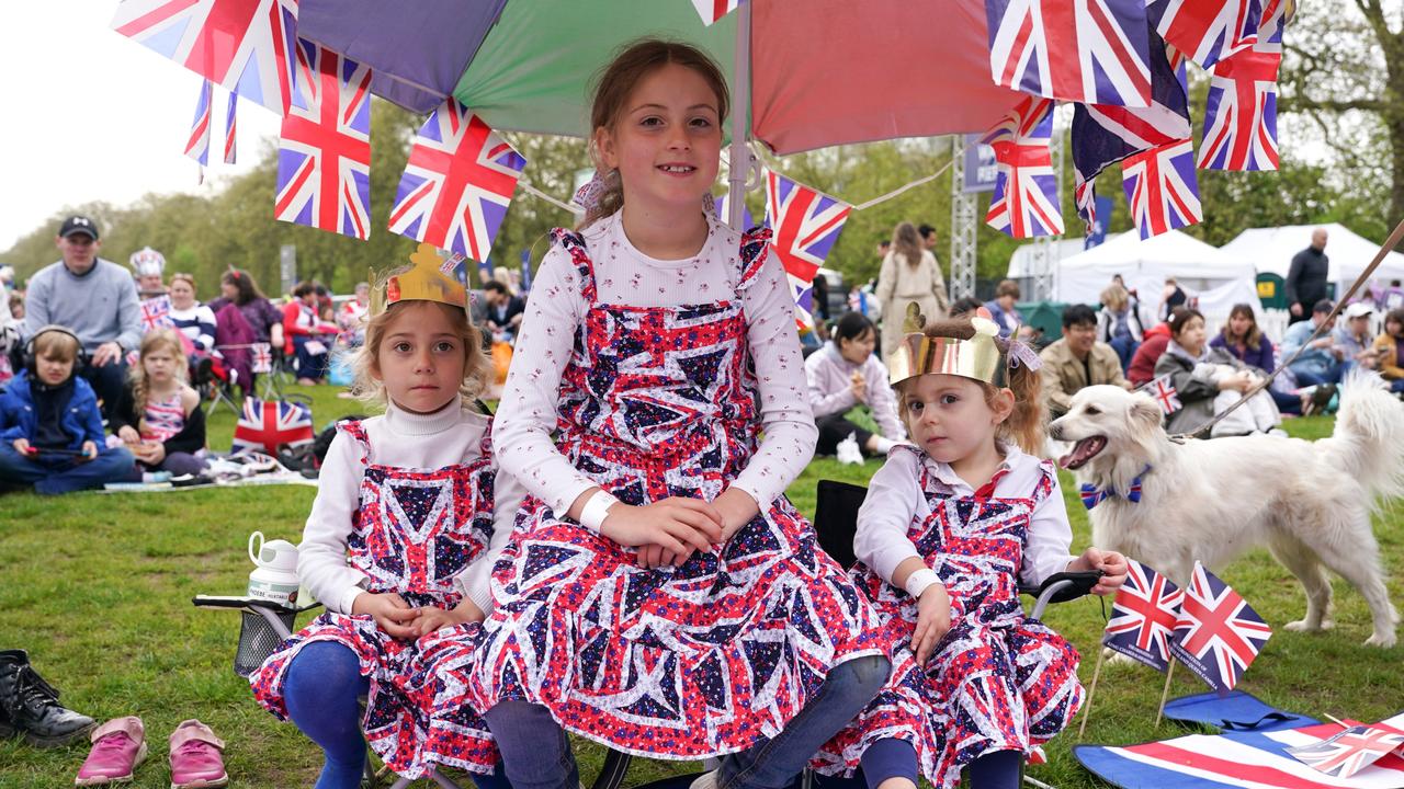 Children wearing Union Flag dresses sit on camp chairs in Hyde Park where giant screens will show coverage of the Coronation. Picture: Getty Images