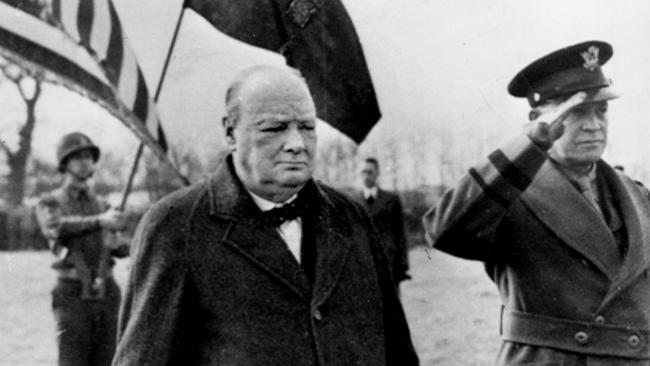 British prime minister Winston Churchill stands alongside General Dwight Eisenhower while reviewing troops as they prepare for the invasion.