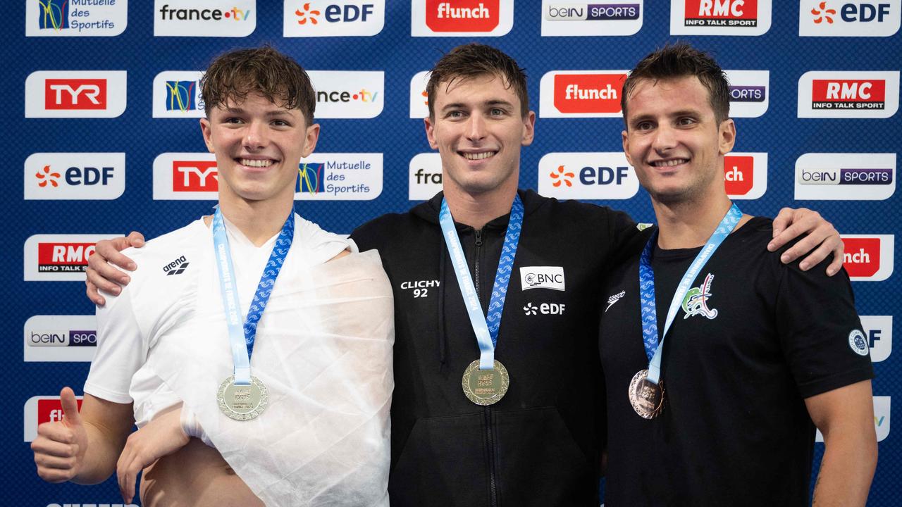 (From L to R) France's Rafael Fente Damers (2nd placed), France's Maxime Grousset (1st placed) and France's Hadrien Salvan (3rd placed) celebrate on the podium. (Photo by SEBASTIEN BOZON / AFP)