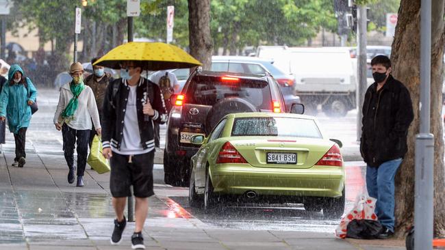 People scurry in the rain in October last year. Picture: NCA NewsWire/Brenton Edwards