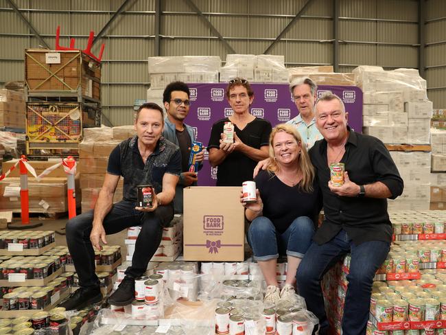 Band members Jimmy Barnes, Phil Small, Charley Drayton, Ian Moss and Don Walker with Renee Pettifer, who has received help from Foodbank. Picture: Jonathan Ng