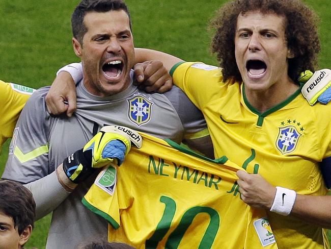 Brazil's David Luiz and goalkeeper Julio Cesar hold the jersey of injured teammate Neymar as they sing the national anthem before the World Cup semifinal soccer match between Brazil and Germany at the Mineirao Stadium in Belo Horizonte, Brazil, Tuesday, July 8, 2014. At left Brazil's Maicon.(AP Photo/Themba Hadebe)