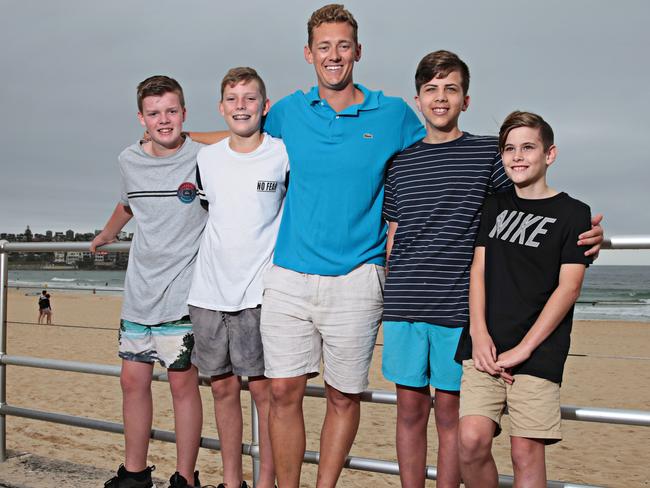 Jaime Privett, 13, Zac Brown, 13, Ben Whitehouse, 14, and Pat Whitehouse, 11, with Tent ‘Maxi’ Maxwell at Bondi Beach. Picture: AAP Image/Adam Yip