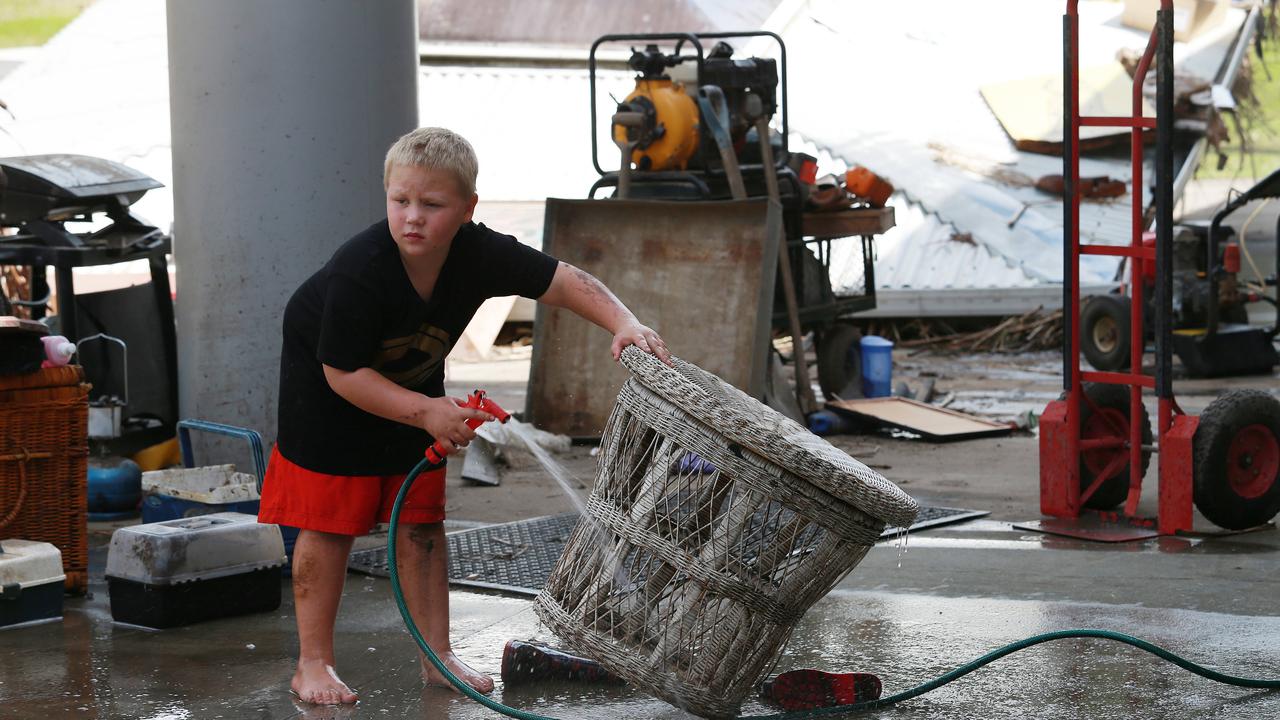 Ashton Lauren, 6, helps clean a friends house on Albert St, Logan.