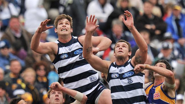 Tom Hawkins and Cameron Mooney fly for a mark against the West Coast Eagles in 2010.