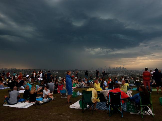 New Years Eve 2018 - 9pm Fireworks display from Dudley Page Reserve in Dover Height. Revellers prepare for rain as a storm front moves through. Picture: Toby Zerna