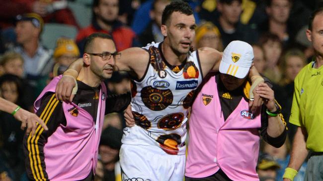 Jon Ceglar in the hands of Hawthorn trainers after injuring his knee. Picture: Daniel Wilkins