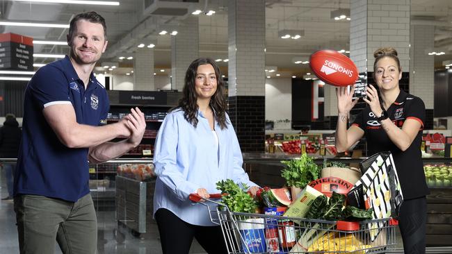 AFL stars Patrick Dangerfield and Steph Chiocci with shopper Eliza Davies at Coles Richmond Traders. Picture: Martin Keep