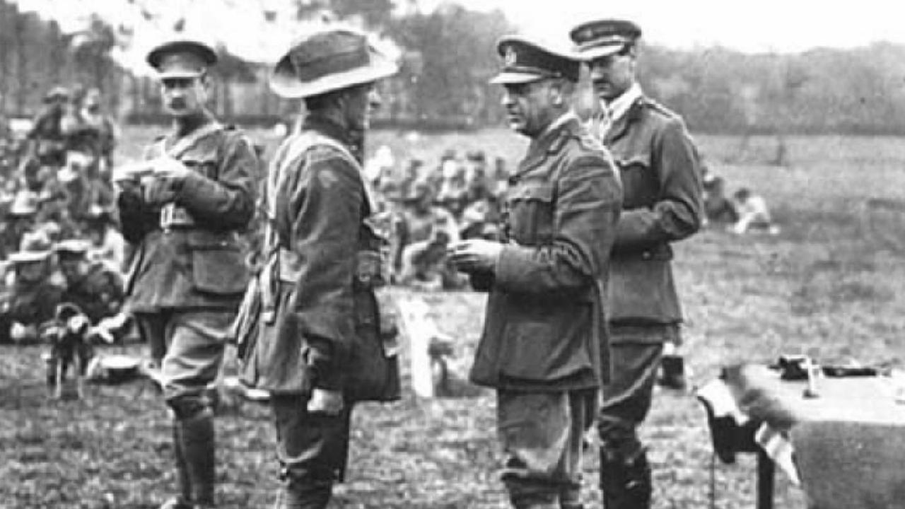 WWI hero Sir John Monash presenting a decoration to a soldier iln the Australian Imperial Force after the Battle of Le Hamel in 1918.