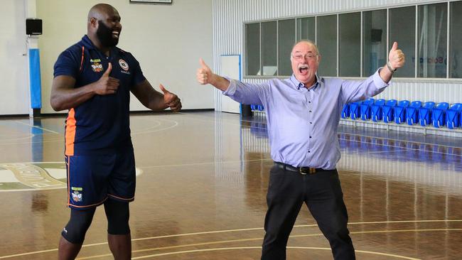 Leichardt MP Warren Entsch is all smiles with Taipans player Nathan Jawai after landing a swish.