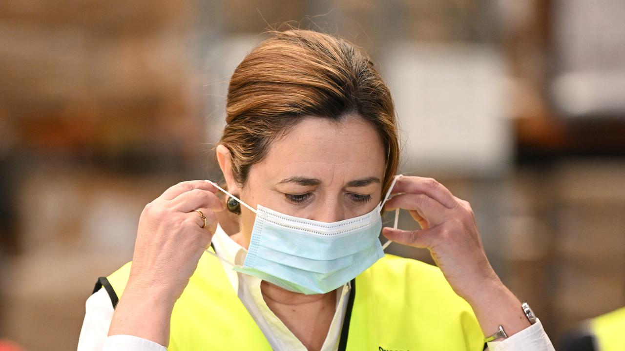 Queensland Premier Annastacia Palaszczuk puts on her mask during a press conference in January 2022. Picture: NCA NewsWire / Dan Peled