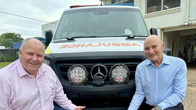 St John NT chief executive Andrew Tombs and Administrator of the Northern Territory Hugh Heggie with ambulance #74 and a Cyclone Tracy commemorative number plate. Picture: Sam Lowe