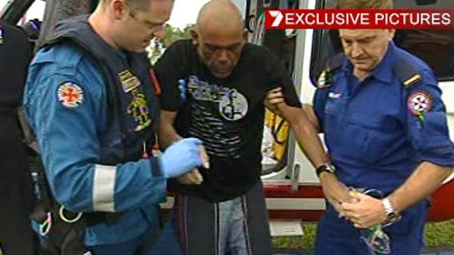 Rescue helicopter crewmen help JJ as he arrives at Ballina Hospital after being plucked form the sea after 30 hours. Picture: Channel 7