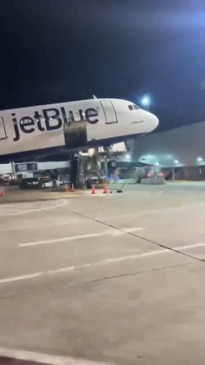 Terrifying moment plane tilts backwards as passengers disembark