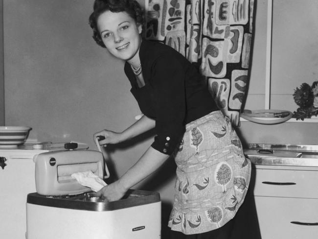 Mrs Audrey Marland won a Bride of the Year contest in 1955, and this was illustrated at the time showing her being a good wife by doing the washing. We should have moved on but we haven’t. Picture: Dennis Oulds/Central Press/Hulton Archive/Getty Images