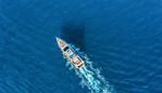 ESCAPE: A-Z TRAVEL_C IS FOR CRUISING, Kendall Hill - 24FEB19. Yacht at the sea in Europe. Aerial view of luxury floating ship at sunset. Colorful landscape with boat in marina bay, blue sea. Top view from drone of yacht. Luxury cruise. Seascape with motorboat Picture: iStock