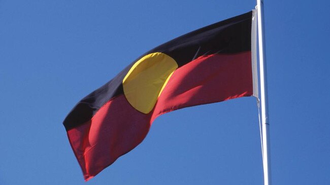 If Woolies wants to help Indigenous people, it should do more than fly the Aboriginal flag.