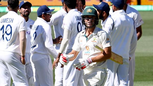 Australia's batsman Joe Burns (C) walks back to the pavilion as Indian players celebrate his dismissal on day two of the first cricket Test match between Australia and India in Adelaide on December 18, 2020. (Photo by William WEST / AFP) / --IMAGE RESTRICTED TO EDITORIAL USE - STRICTLY NO COMMERCIAL USE--