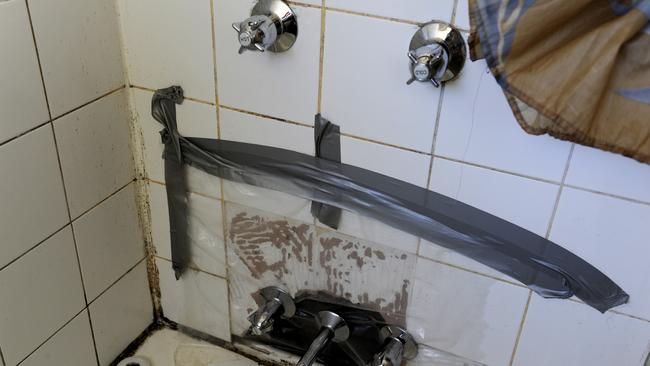 A shower area shows the results of neglect and abuse in public housing area in Willmot in Sydney’s west.