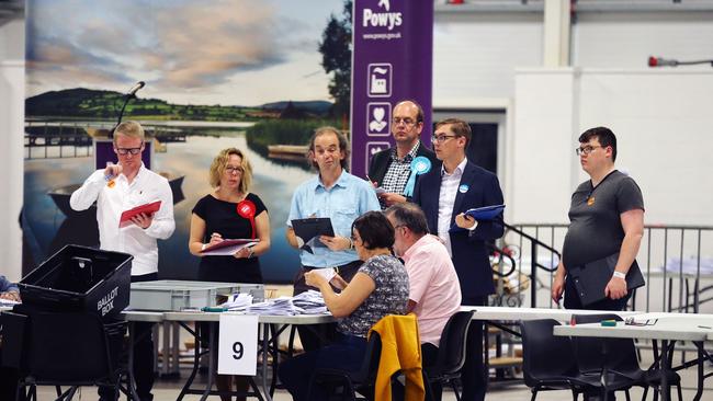 Ballot papers are counted during the Brecon and Radnorshire by-election count at the Royal Welsh Showground in Builth Wells, Wales on August 2, 2019. - Britain's Boris Johnson faces his first test at the ballot box Thursday in a by-election that could reduce his parliamentary majority to just one, as his new government vowed to double funding for a possible no-deal Brexit. Johnson's Brexit plan could also become harder to enact as his governing Conservative Party looks set to lose the Welsh seat of Brecon and Radnorshire to a pro-Europe candidate on Thursday. (Photo by Isabel INFANTES / Isabel Infantes/AFP/Getty Images / AFP)