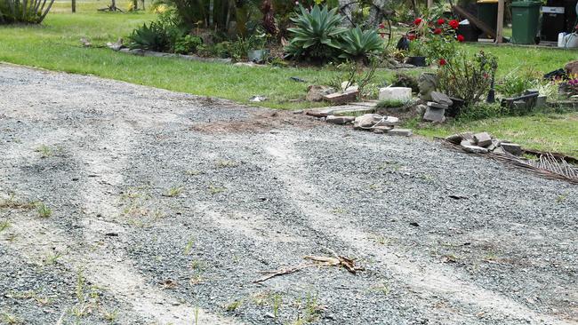 Car burnout tracks leading to bloody clothing at the attempted murder scene where a 27-year-old man allegedly drove over a woman in her back yard, Namatjia Court, Caboolture. Photographer: Liam Kidston.