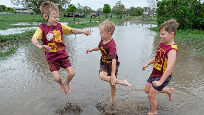 Ryan (6), Max (7) and Hayden (8) Clark playing in puddles left after rain came through at their North Bundaberg paddock. Photo - Paul Beutel