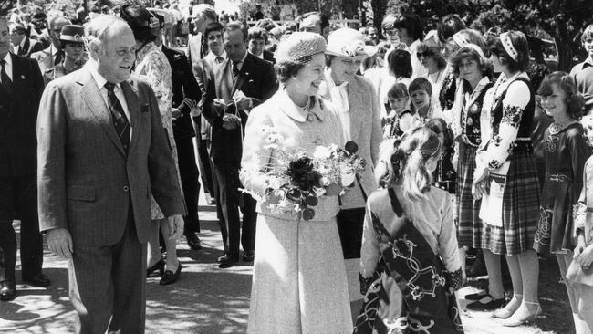 Queen Elizabeth II meets children and receives posies from Adelaide’s various cultural groups at Adelaide Country Club, followed by SA Premier David Tonkin, during royal visit to South Australia, 11 October 1981.