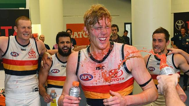 Elliott Himmelberg of the Crows is sprayed with drinks after the Crows big win over Carlton. Picture: Getty Images