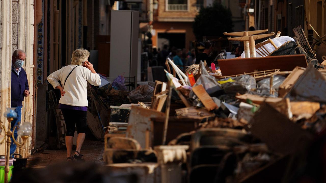 Residents say the disaster response has been too slow as debris cleared from houses is left piled up in a street in Sedavi, full of loose items that would become even more hazardous if another storm strikes. Picture: Manaure Quintero/AFP