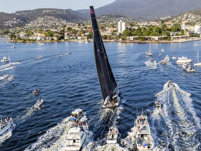 In a photo provided by Role, Comanche, center, is surrounded by spectator craft on arrival to Hobart, Australia, to claim victory in the Sydney to Hobart yacht race Saturday, Dec. 28, 2019. (Rolex/Carlo Borlenghi via AP)