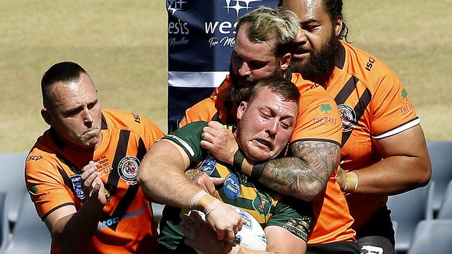 No place to go: Mittagong's Brayden Boaden is wrapped up by the Tigers. Picture: John Appleyard