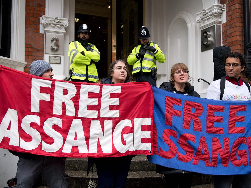 Protesters and supporters holding banners that read "Free Assange" outside the Ecuadorean Embassy in London. Picture: AFP