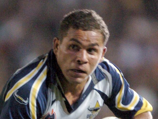 Matt Bowen escapes a Darren Lockyer tackle - Broncos vs Nth Qld Cowboys  at Dairy Farmers Stadium NRL 18.9.04