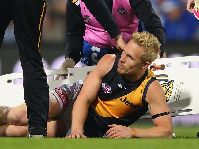 HOBART, AUSTRALIA - JUNE 03: Steven Morris of the Tigers reacts after he suffers a leg injury in a contest with Robin Nahas of the Kangaroos during the round 11 AFL match between the North Melbourne Kangaroos and the Richmond Tigers at Blundstone Arena on June 3, 2016 in Hobart, Australia. (Photo by Michael Dodge/Getty Images)