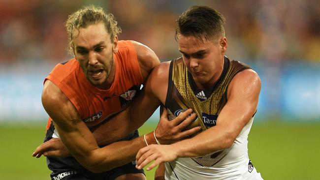 Hawk Kieran Lovell, right, contests the ball with Matthew Buntine, of the Giants, in the 2016 AFL season. Picture: Brett Hemmings/AFL Media/Getty