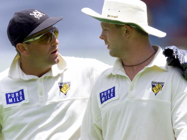 Darren Berry has a word of encouragement to paceman Mick Lewis.