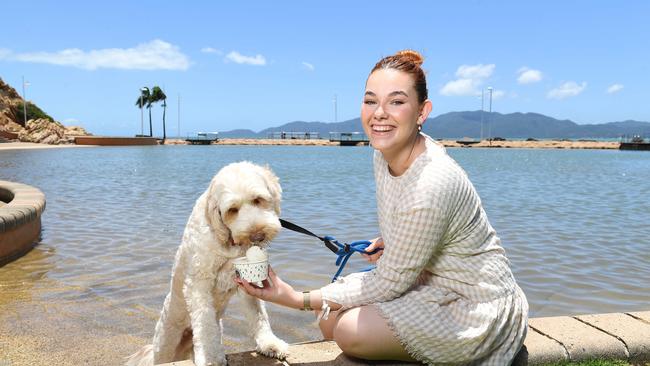 Rockpool Pavilion Venue Manager Tayla Hancock treats 1yo cobber dog, Cyril, to some Doggie Ice cream which they now stock. Picture: Shae Beplate.